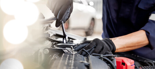Car care maintenance and servicing, Close-up hand technician auto mechanic using the wrench to repairing change spare part car engine problem and insurance service support.
