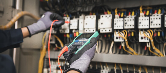Electricity and electrical maintenance service, Engineer hand holding AC multimeter checking...