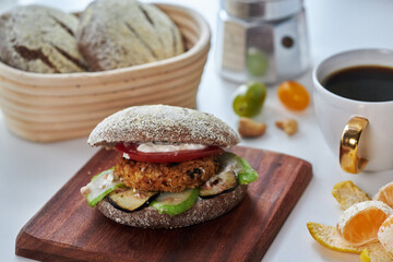 Homemade rye hamburger, stuffed with chicken meat, eggplant, cucumber, tomato and cheese