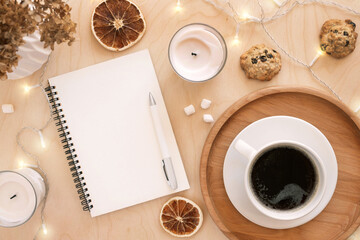 Back to life, goal list concept. Woman's hand writing in empty notebook on wooden table. Resolutions, plan, goals, checklist, idea concept. Top view, flat lay, copy space. 2022. Christmas, New Year