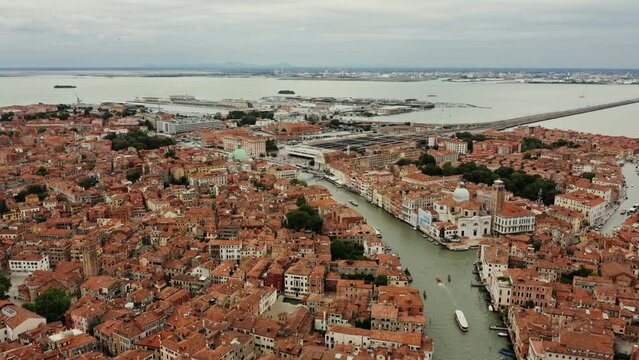 Horizontal panning from a drone, a beautiful view of the old city with traditional houses and canals. Grand Canal, Venice, Italy, bird's eye view video