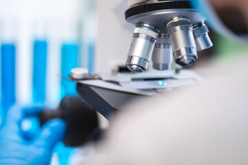 biotechnology scientist using scientific microscope for research in biology medicine laboratory, equipment for chemistry science or microbiology analysis in term of medical technology experiment