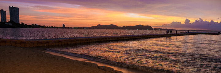 Beach in Pattaya during sunset in Thailand Ban Amphur beach. a tropical beach with palm trees...