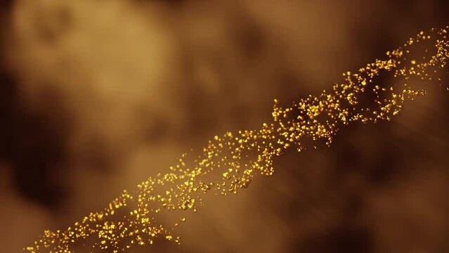 Wave of floating gold nugget particles on an orange background