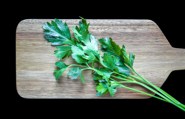 Bunch of parsley stem on a wooden cutting board