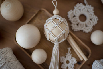 Macrame decor in a wooden box, Christmas ball and stars, handmade, hobby materials.