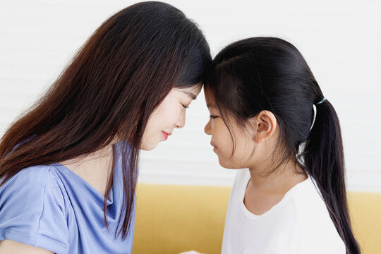 Adorable Asia Happy Family, Cute Little Girl And Her Mother Touching Their Foreheads, Smiling And Looking At Each Other, Warm Love In Family, Happy Mother Day, Kid Have Special Time With Mom.