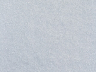 Natural snow texture. Smooth surface of clean fresh snow. Snowy ground. Winter background with snow patterns. Perfect for Christmas and New Year design. Closeup top view.