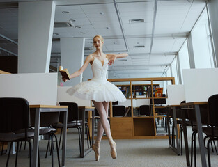 charming ballerina went to the library to choose a new book during a break showing your stretching...