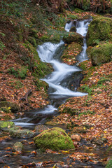 Stunning waterfall landscape image in vibrant Autumn woodland in Lake District