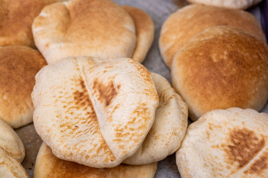 Hot fresh baked traditional arabic bread - Pita, sold at the city farmers market