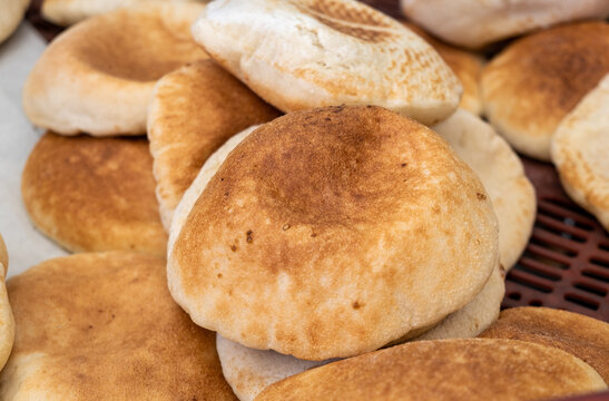 Hot fresh baked traditional arabic bread - Pita, sold at the city farmers market