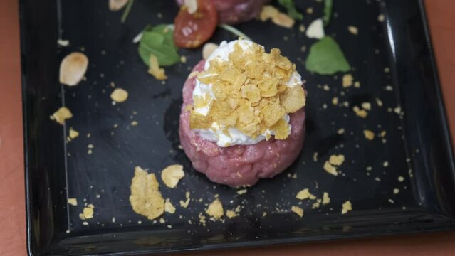 Preparation of meat tartare by a professional chaf in an Italian restaurant kitchen