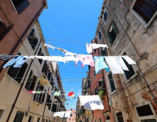 Fototapeta premium clothes hanging out in the sun to dry on a sunny day in the European city