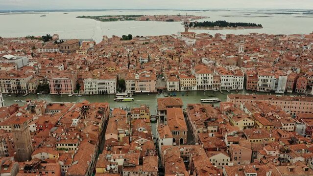 Panoramic video shooting from a drone, a view of the beautiful Italian city on the water. Traditional houses with orange roofs from a bird's eye view. Venice, Italy