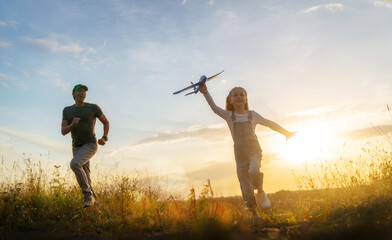 Happy family at sunset