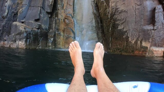 POV (point of view) of a person floating over water looking at landscape view of Python Pool Millstream Chichester Range National Park Pilbara region Western Australia.