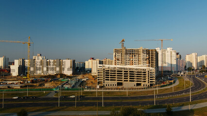 Construction site of a new city block. Construction of multi-storey buildings. Construction site at dawn. Aerial photography.