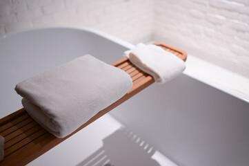 white towels put on bathtub in the bathroom