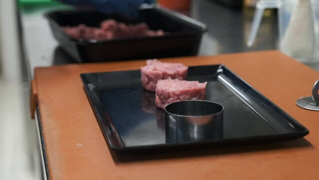 Preparation of meat tartare by a professional chaf in an Italian restaurant kitchen