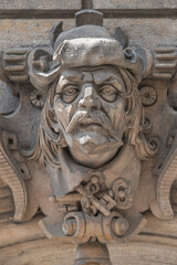 Ancient sculpture of scary, fearful and heavy armed gatekeeper, medieval warrior with weapon in historical downtown of Dresden, Germany, details, closeup. Authentic European old architecture.