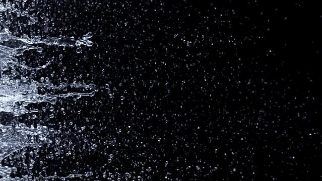 Super Slow Motion Shot of Water Side Splashes Isolated on Black Background at 1000fps.