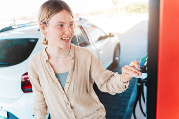 Woman at the gas station pays with the credit card