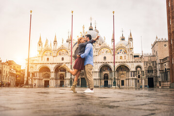 Happy beautiful couple of lovers doing romantic trip in Venice, Italy - Tourists visiting historic...