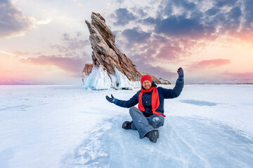 Happy Man tourist adventure landscape background blue ice cave and grotto winter from lake Baikal...