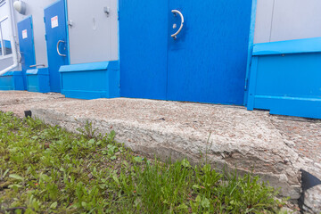 Destruction of cement foundation and blind area of building as result of exposure to water or soil mobility