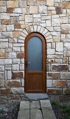 Fototapeta na wymiar wooden doors in a stone wall