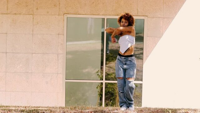 latin american black girl dancing modern dance in the street