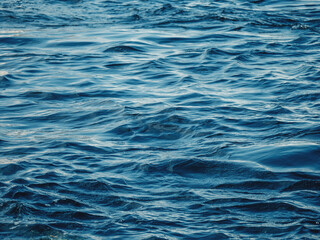 Dark blue water with waves. Ocean, sea or deep river surface. Liquid background.