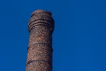 Old brick chimney. Pipe from an old factory