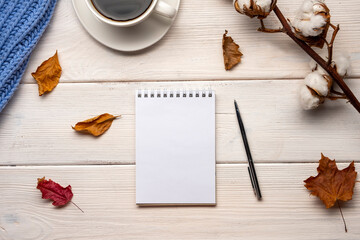 Naklejka na ściany i meble Cup of coffee, plaid, gratitude journal, autumn leaves on white wooden background.