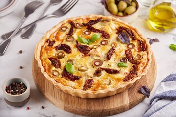 Quiche open tart pie with chicken meat, green olives and sundried tomatoes. Savory taste. Italian...