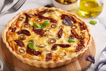 Quiche open tart pie with chicken meat, green olives and sundried tomatoes. Savory taste. Italian...