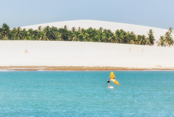 Brasil, Jericoacoara white beach with surfer
