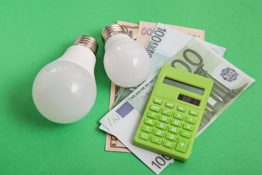 Light bulb, money on green background. Renewable Energy. Environmental protection, renewable, sustainable energy sources. Concept of competition for Green Energy market - Powered by Adobe