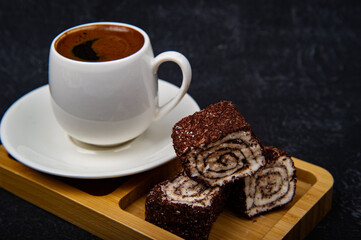 Turkish Delight and Turkish coffee in wooden plate on black background