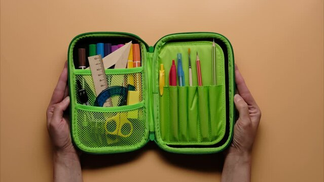 Stop motion of colored school pencil case with school supplies. Back to school and writing for education concept. 4k