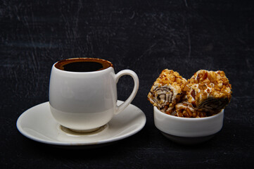 Turkish coffee and Turkish delight on black background.