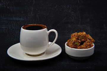 Turkish coffee and Turkish delight on black background.