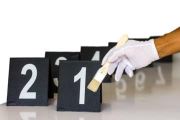 Forensics gloves holding a paint brush to label a figure which ranged respectively
