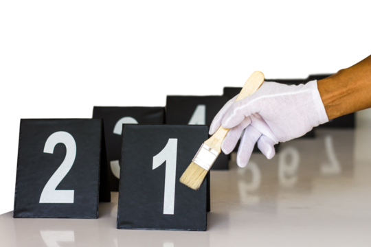 Forensics gloves holding a paint brush to label a figure which ranged respectively