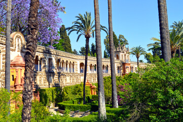Fototapeta premium Romantic gardens of the Alcazar of Seville and the Gallery of Grutesques, Spain. Unforgettable visit to the Alcazar of Seville. Gardens from Spain