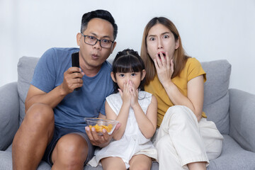 Portrait of Asian Happy Family Watch Excited Movie on Sofa