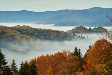Panoramic image autumn landscape, clouds over hills and forest with mountains on background. Carpathians, Ukraine