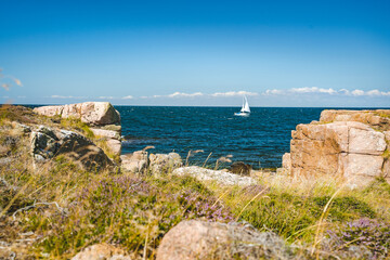 sailboat at nothern Bornholm coastline in baltic sea, Denmark