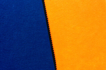 ultramarine blue and orange felt material background with zig zag element